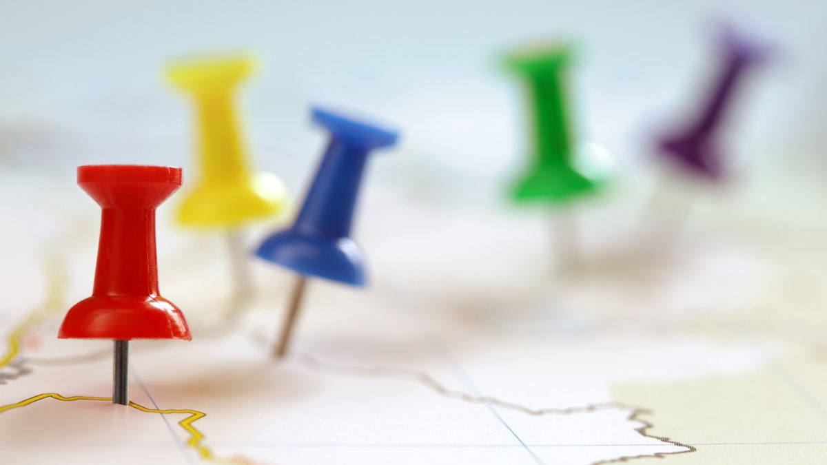 Colored pushpins on a map.