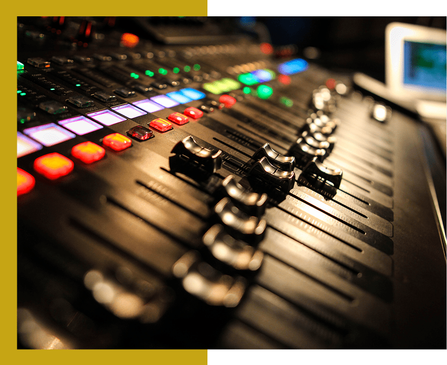 Audio mixing console with colorful control knobs.